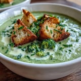 Crisp broccoli florets and aromatic vegetables simmered in broth for a creamy soup.