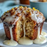Golden lemon poppy seed muffins topped with a glossy, tangy glaze — perfect for spring brunch or a sweet snack.