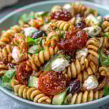 Refreshing Easy Picnic Pasta Salad tossed in zesty Italian dressing, featuring crisp cucumbers, tomatoes, and bell peppers for a satisfying side dish.  