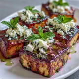 Grilled watermelon salad with feta and mint, juicy watermelon wedges lightly charred and topped with creamy cheese and fresh herbs.