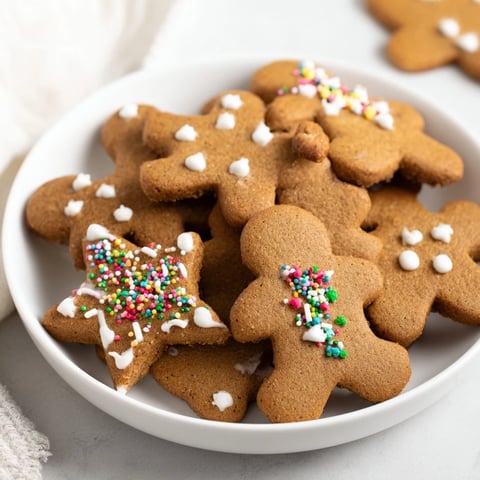 Warm, molasses-infused Gingerbread Cookies, freshly baked and ready to be decorated with festive icing.