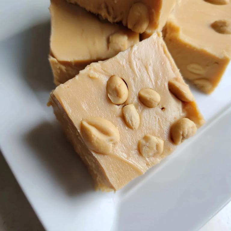 Homemade peanut butter fudge recipe, cut into neat squares, offering a delightful creamy and sweet treat.