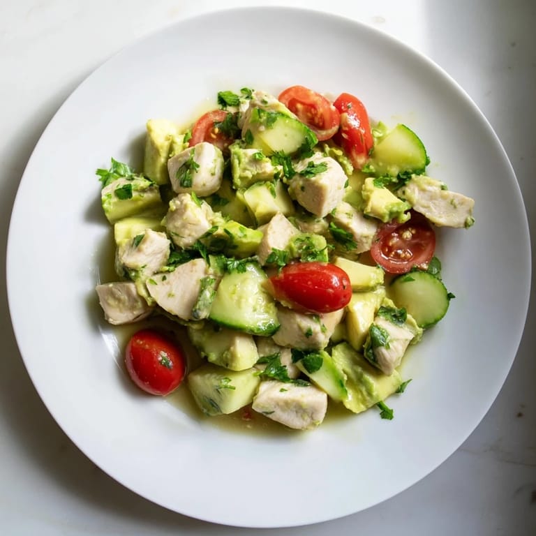 Freshly tossed Avocado Chicken Salad featuring diced chicken, avocado, cucumber, and herbs with lime dressing.  