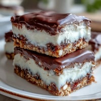 ALT text: Decadent clotted cream cookie bars with white chocolate chunks, baked golden and rich, perfect for dessert lovers.  